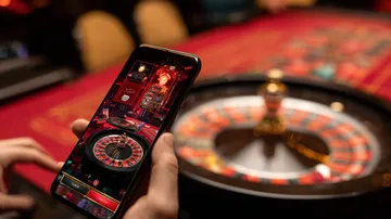 A cheerful woman in traditional clothing using her smartphone during a festive moment, showing how easily the BDT88 app fits into everyday life.