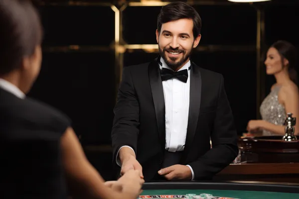 A woman in a luxurious green gown next to an ornate roulette wheel, capturing the upscale casino mood of BDT88.